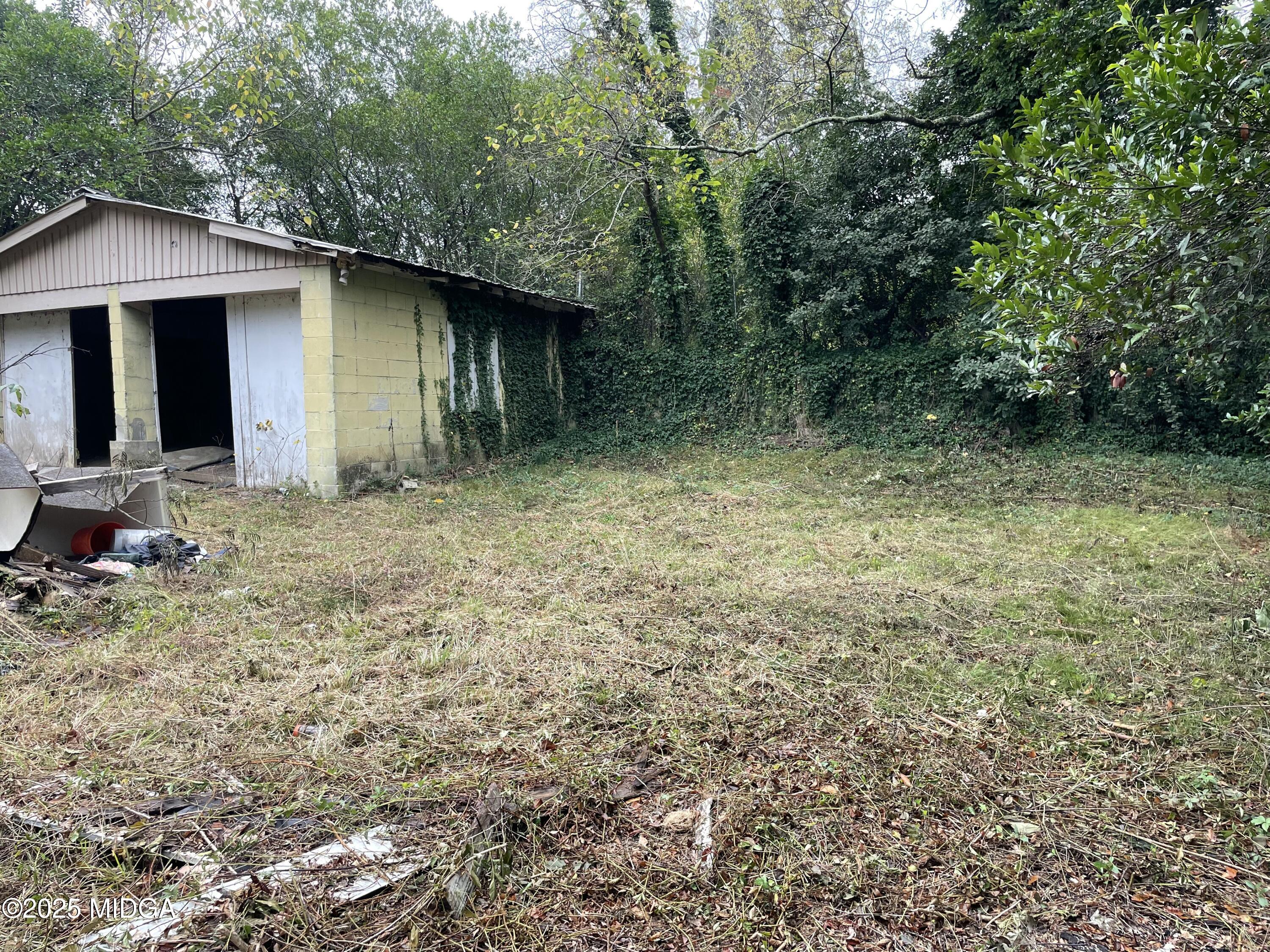 648 Hightower Road Macon, GA 31206 - Photo 17 of 21 a yellow house in middle of the forest