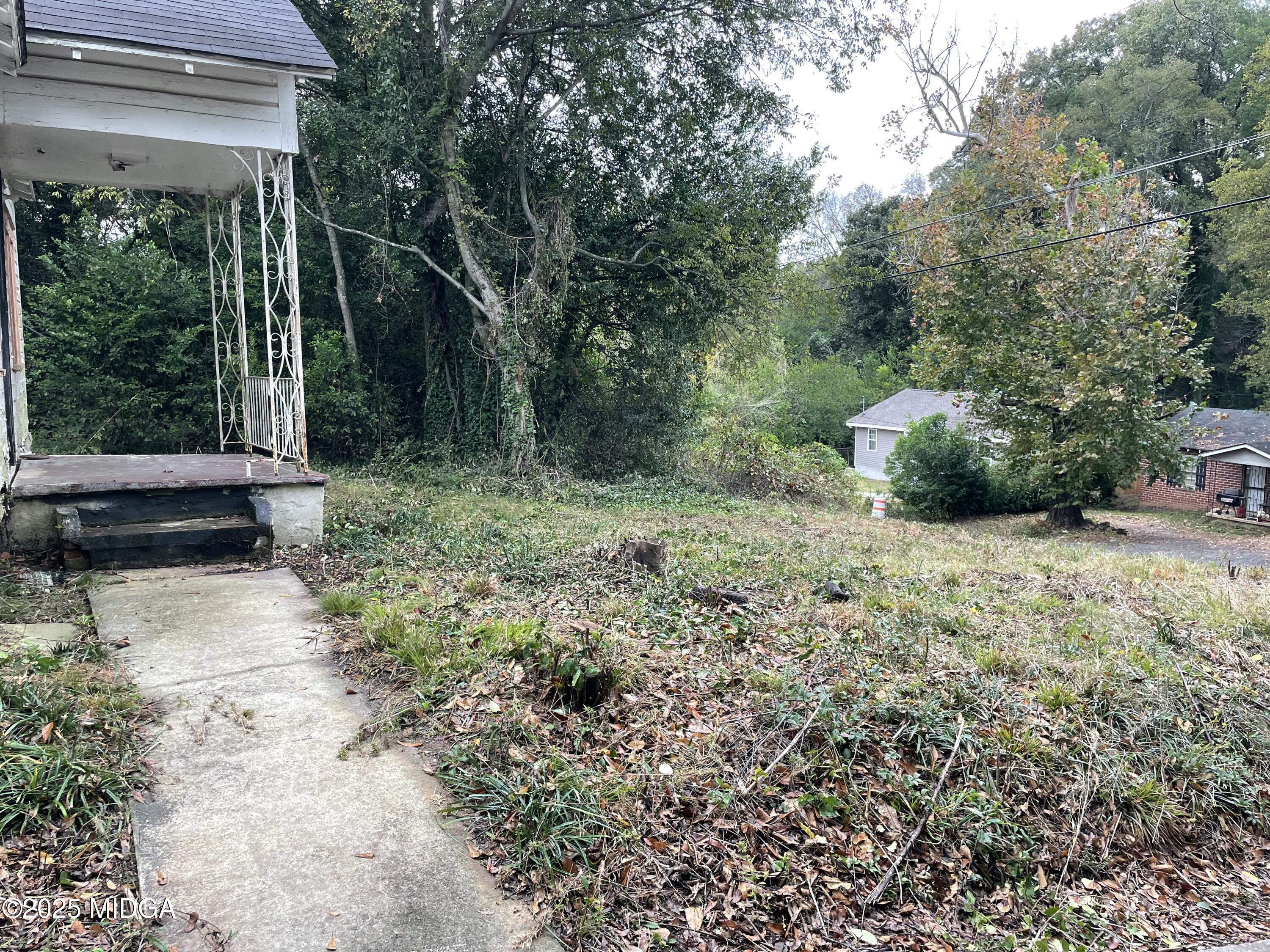 648 Hightower Road Macon, GA 31206 - Photo 3 of 21 a view of a backyard with potted plants and large trees