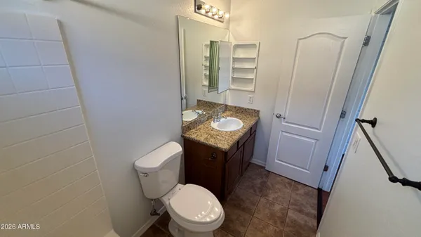 a white toilet sitting next to a sink