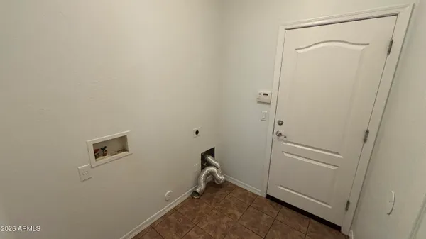 a room with walk in closet and wooden floor