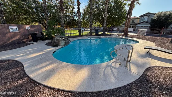 a view of a swimming pool with outdoor seating