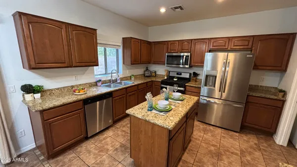 a kitchen with refrigerator cabinets and a sink