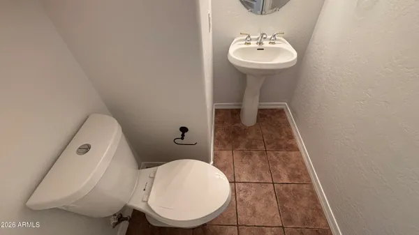 a bathroom with a sink toilet and a mirror