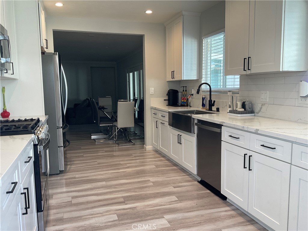 114 South Acacia Avenue Rialto, CA 92376 - Photo 9 of 21 a kitchen with a sink stove and cabinets