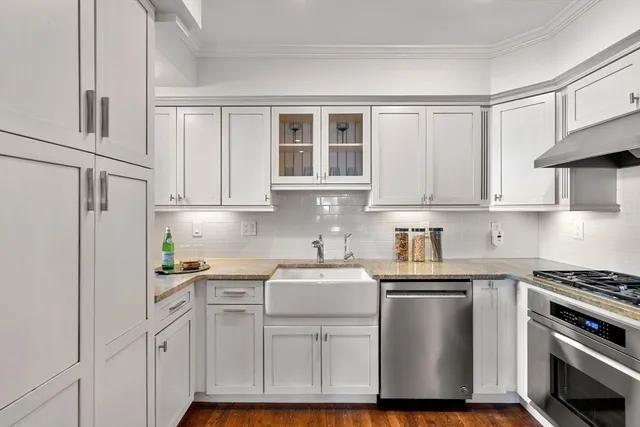 a kitchen with white cabinets and white appliances