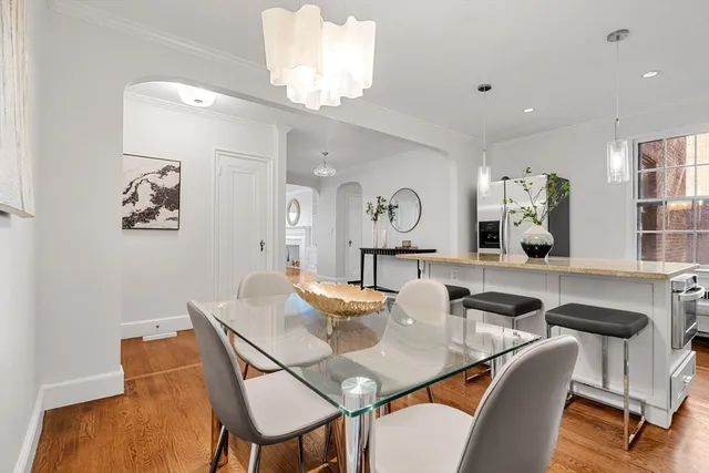 a view of a dining room with furniture and a chandelier