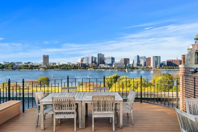 a view of swimming pool with outdoor seating and city view