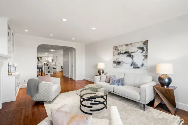 a living room with furniture a rug and a painting on the wall