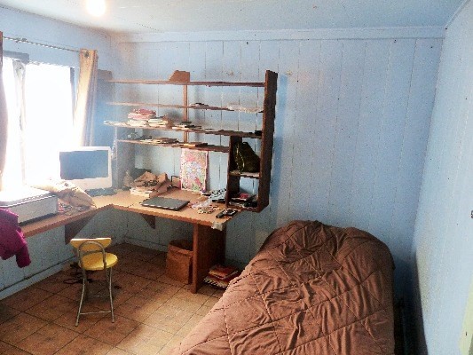 84-1127 Bruner Road Captain Cook, HI 96704 - Photo 18 of 25 a bedroom with a bed and a chair in it