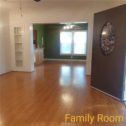 a view of kitchen and hallway with wooden floor