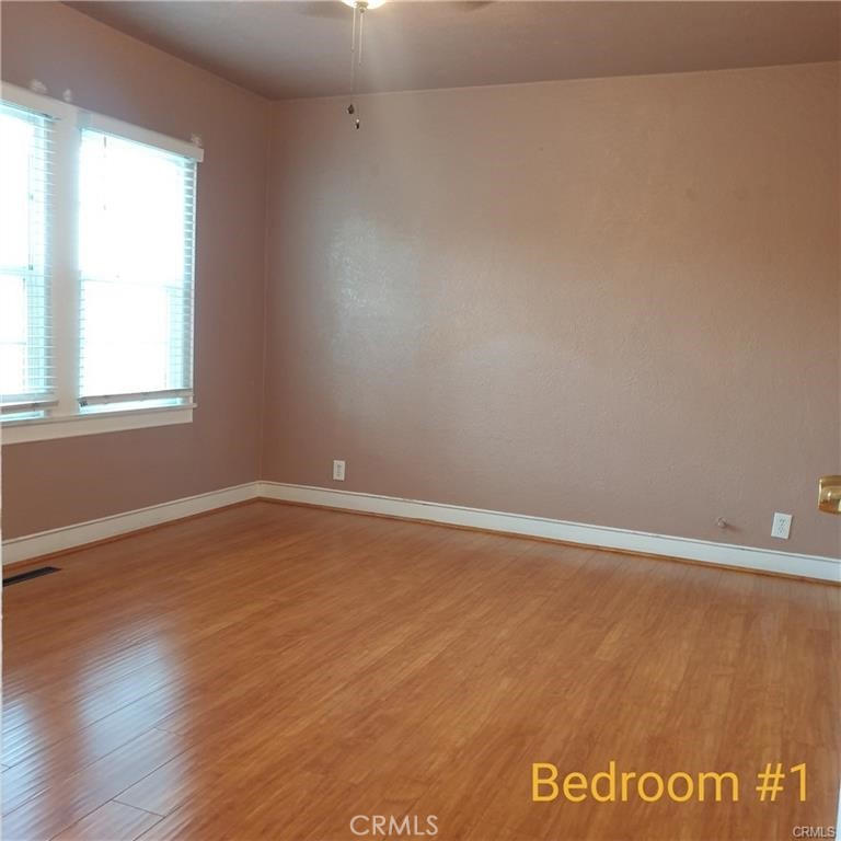 166 North Lemon Avenue Walnut, CA 91789 - Photo 10 of 16 an empty room with wooden floor and windows