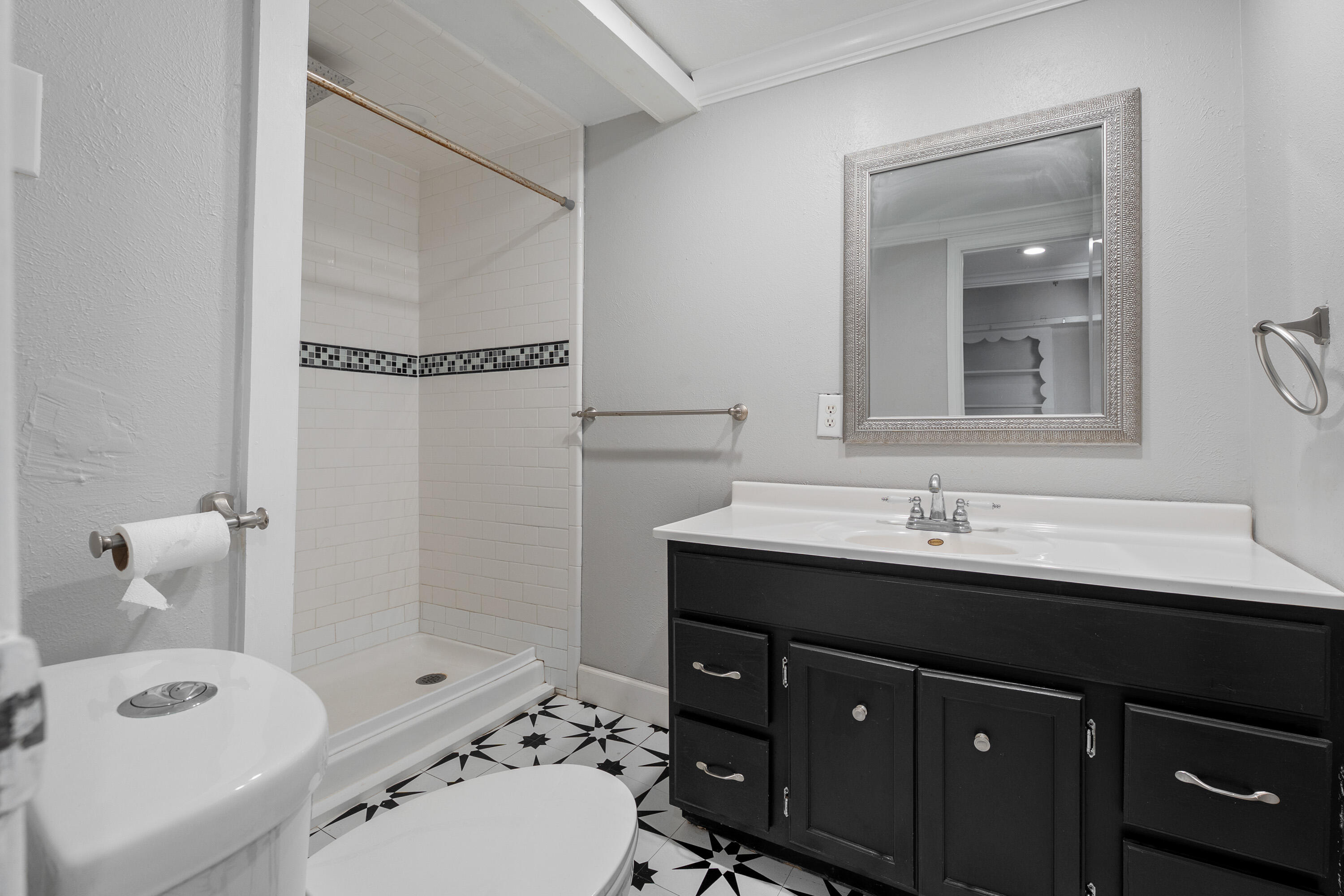 2702 23rd Street Lubbock, TX 79410 - Photo 11 of 30 a bathroom with a sink a toilet and shower