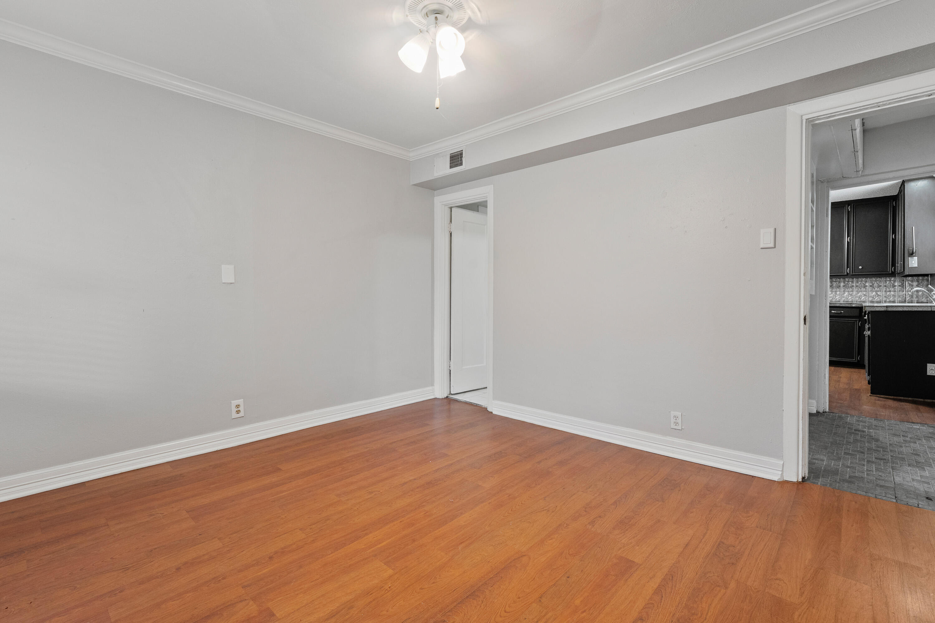 2702 23rd Street Lubbock, TX 79410 - Photo 13 of 30 a view of an empty room with window and wooden floor