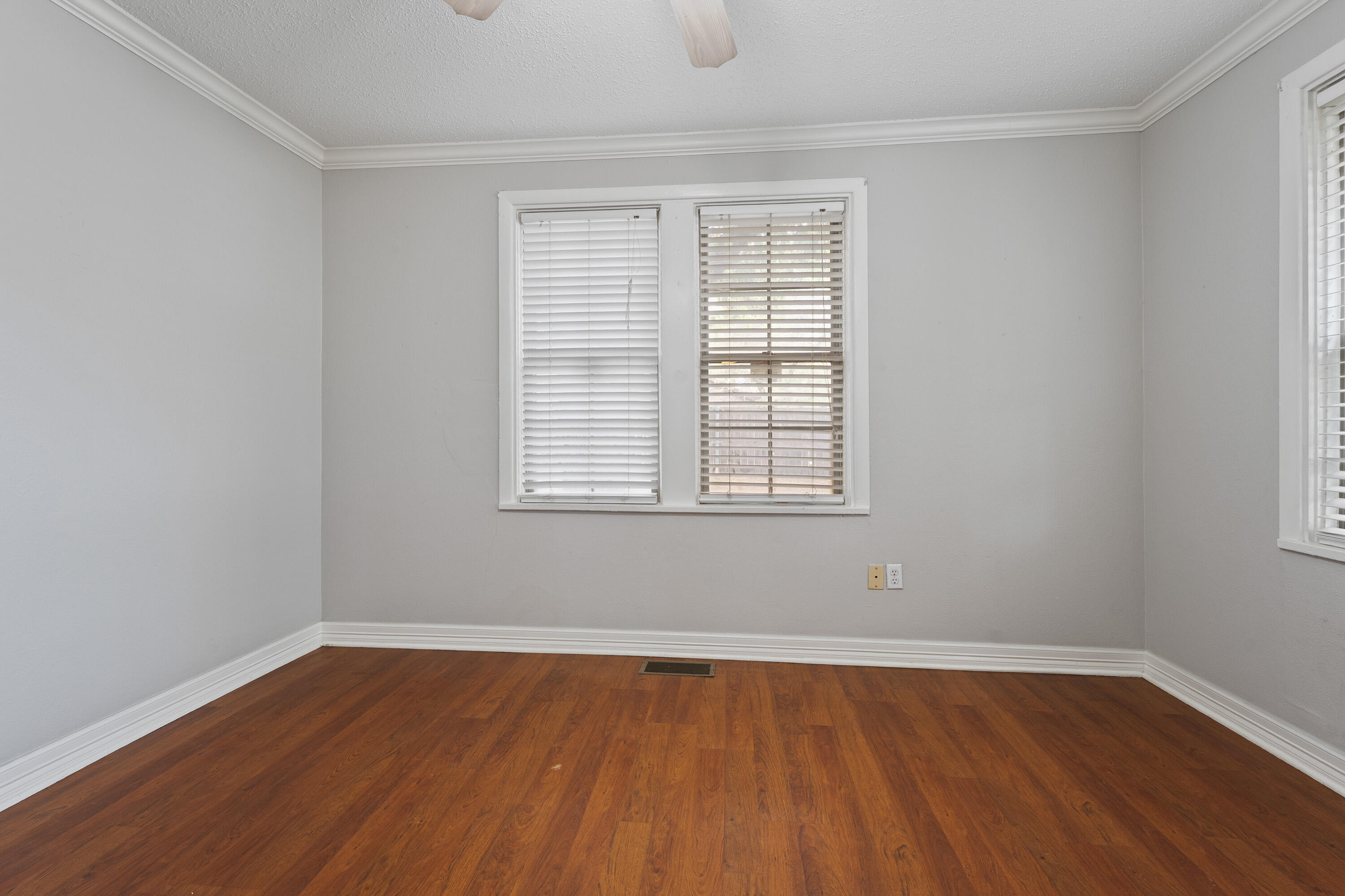 2702 23rd Street Lubbock, TX 79410 - Photo 14 of 30 wooden floor in an empty room with a window