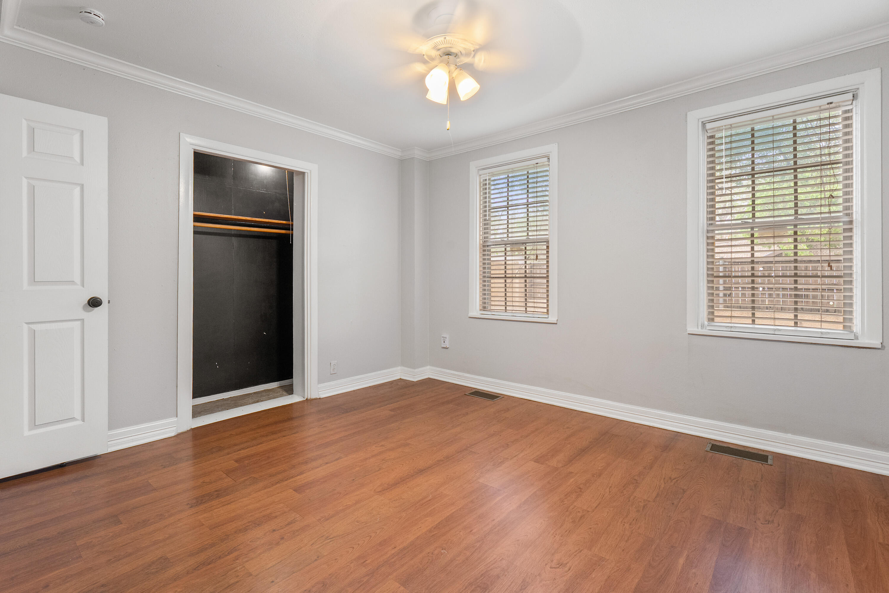 2702 23rd Street Lubbock, TX 79410 - Photo 15 of 30 a view of an empty room with a window and wooden floor