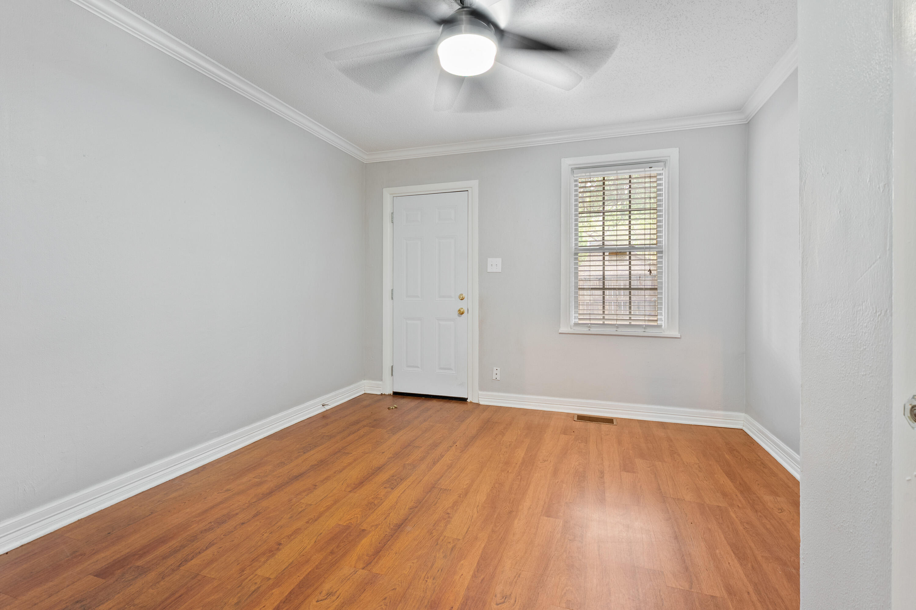 2702 23rd Street Lubbock, TX 79410 - Photo 18 of 30 an empty room with wooden floor and windows
