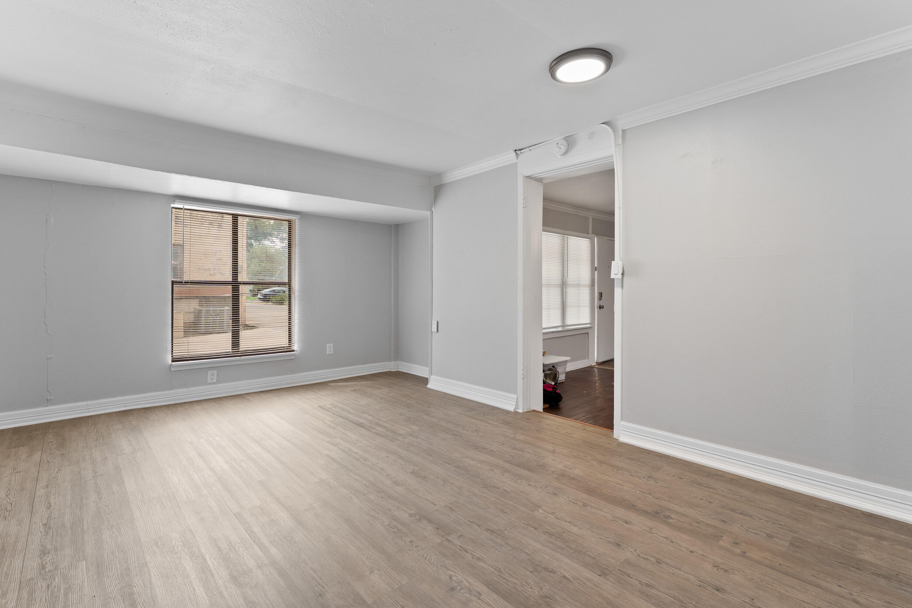 2702 23rd Street Lubbock, TX 79410 - Photo 28 of 30 an empty room with wooden floor and windows