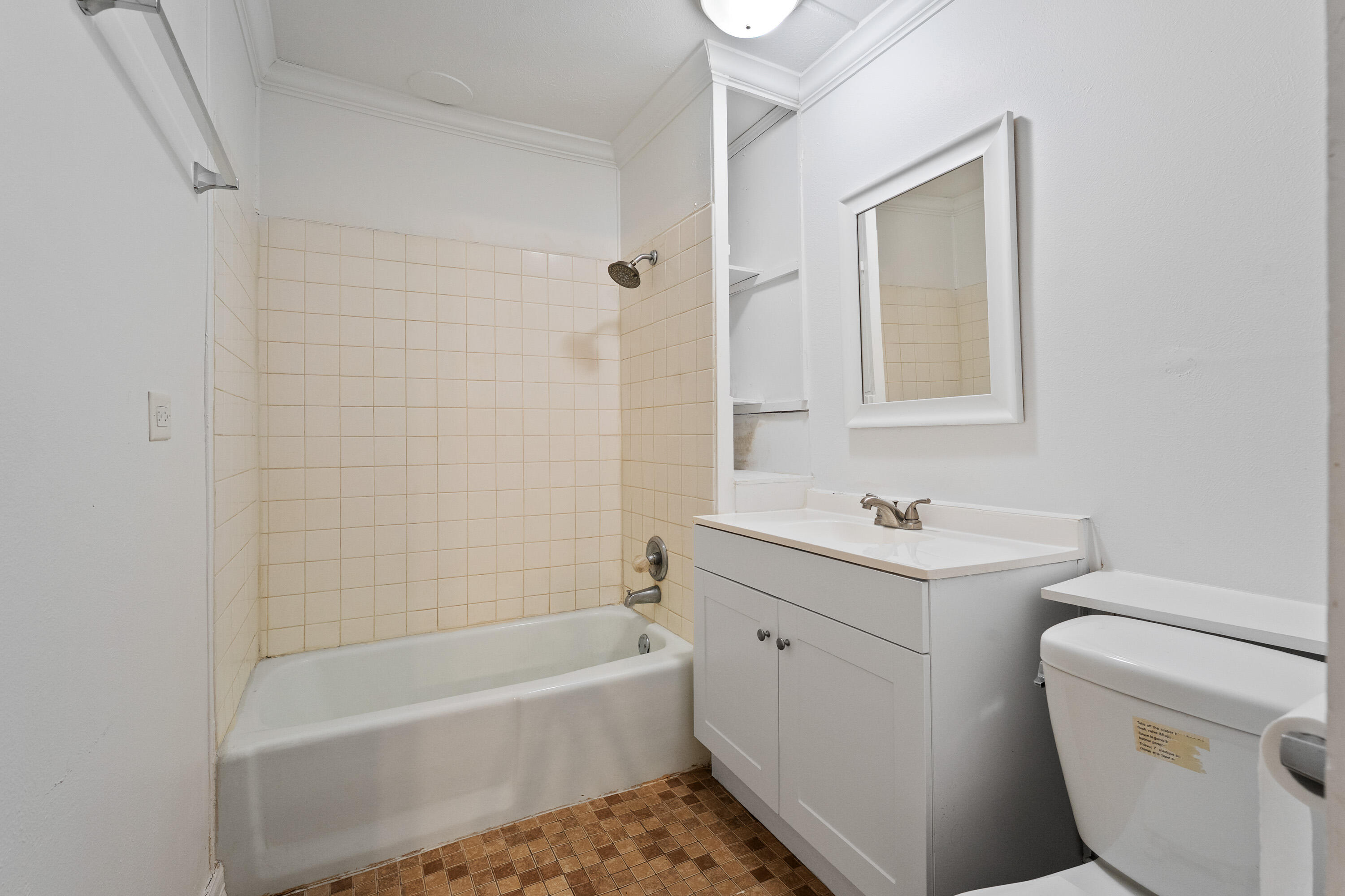 2702 23rd Street Lubbock, TX 79410 - Photo 30 of 30 a bathroom with a sink a toilet and bathtub