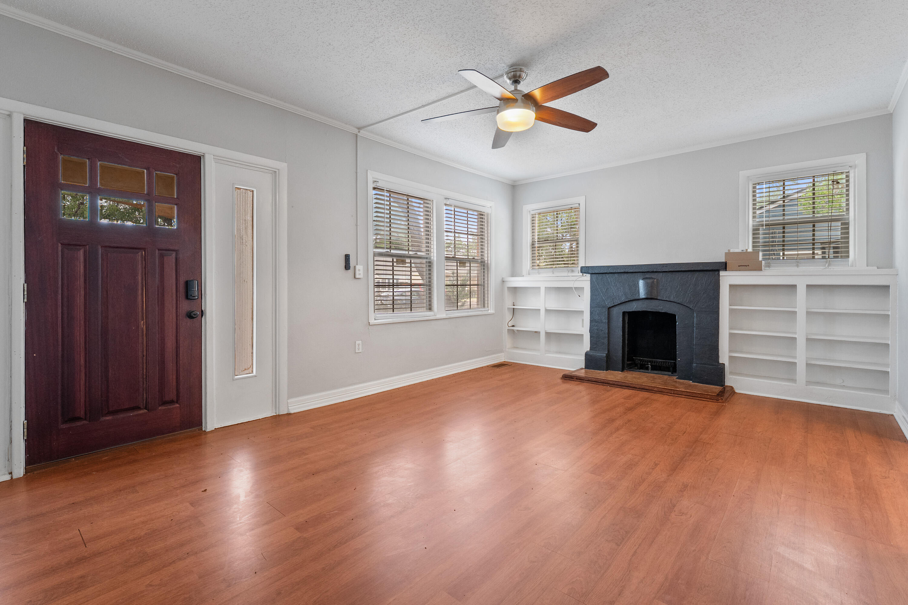 2702 23rd Street Lubbock, TX 79410 - Photo 4 of 30 an empty room with windows fireplace and a window