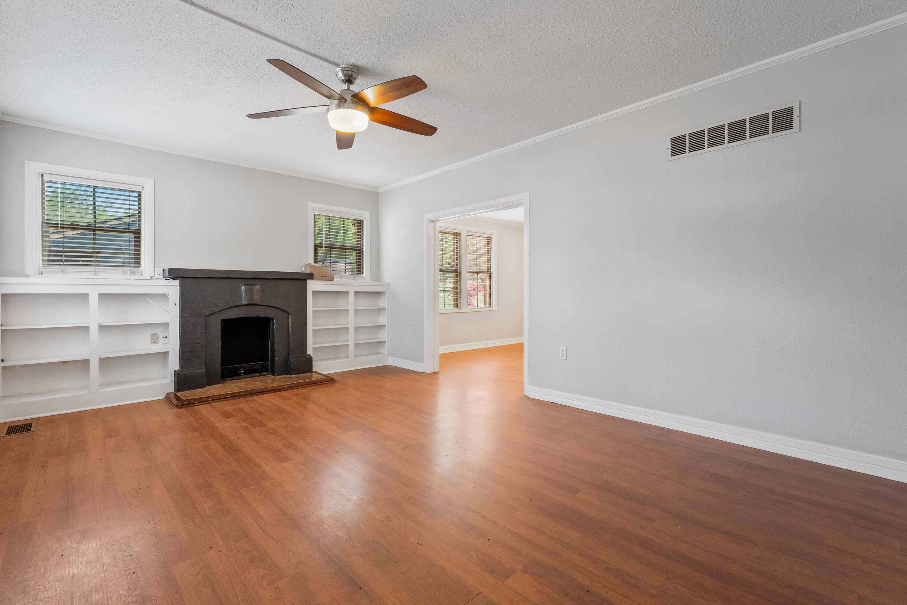 2702 23rd Street Lubbock, TX 79410 - Photo 5 of 30 a view of empty room with wooden floor and fireplace