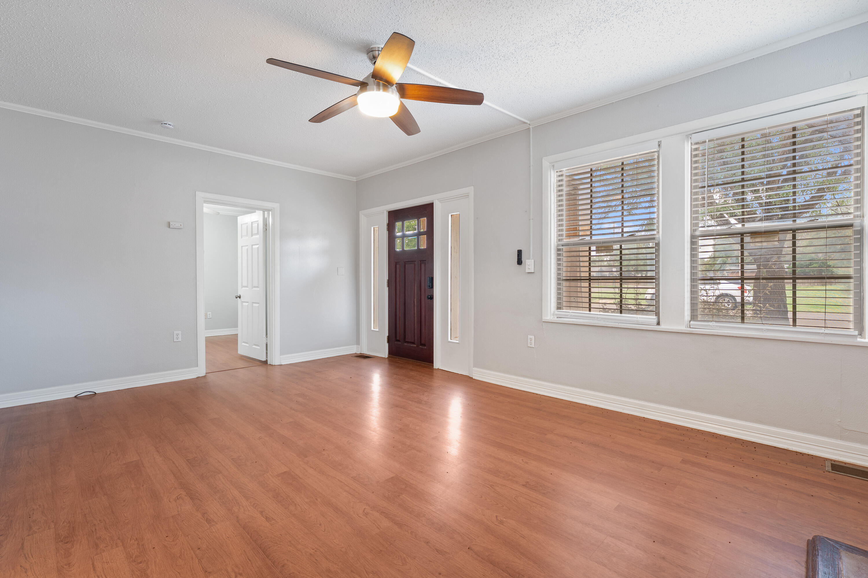 2702 23rd Street Lubbock, TX 79410 - Photo 6 of 30 a view of empty room with wooden floor and fan