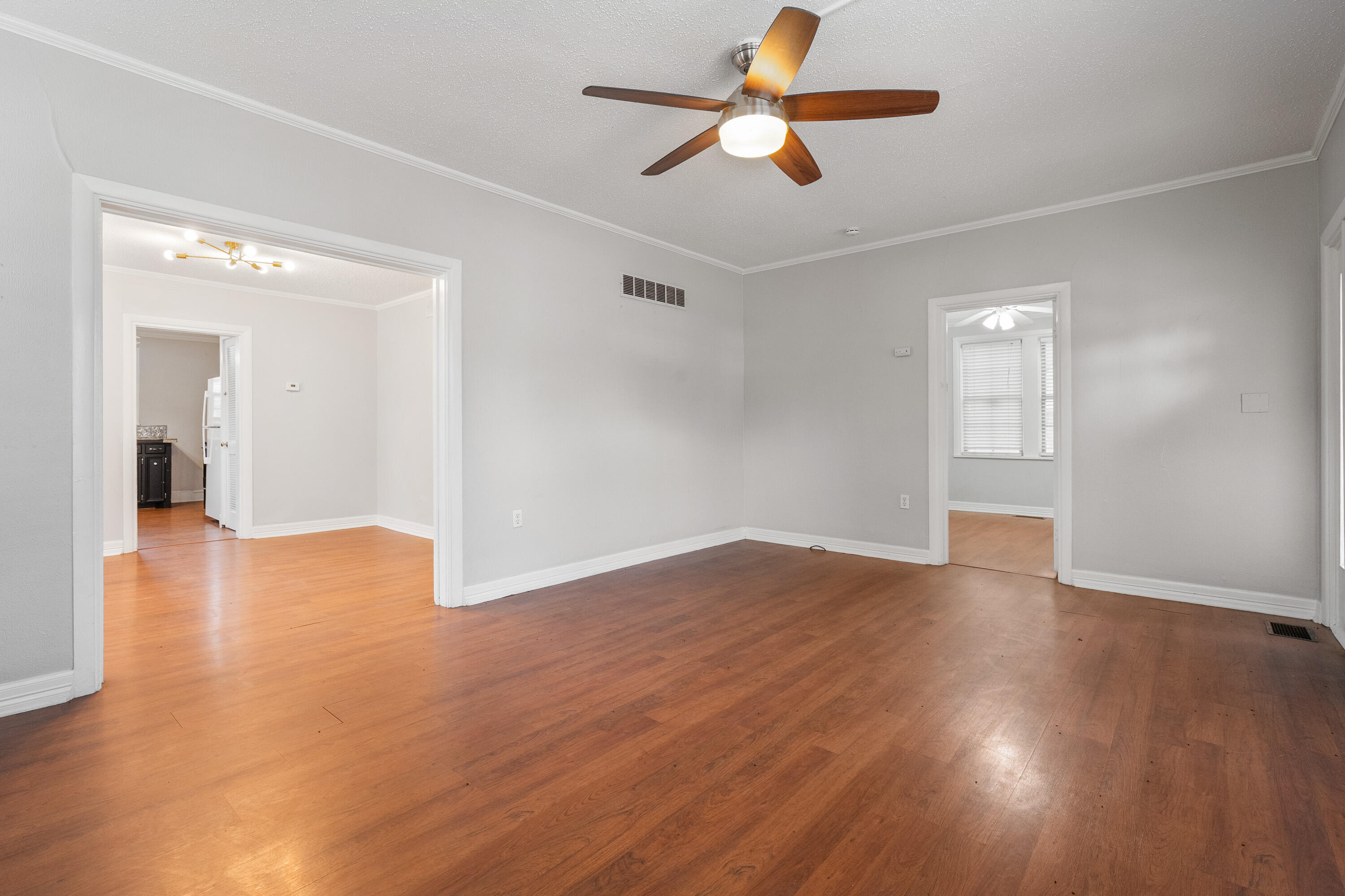 2702 23rd Street Lubbock, TX 79410 - Photo 7 of 30 a view of an empty room with window and wooden floor