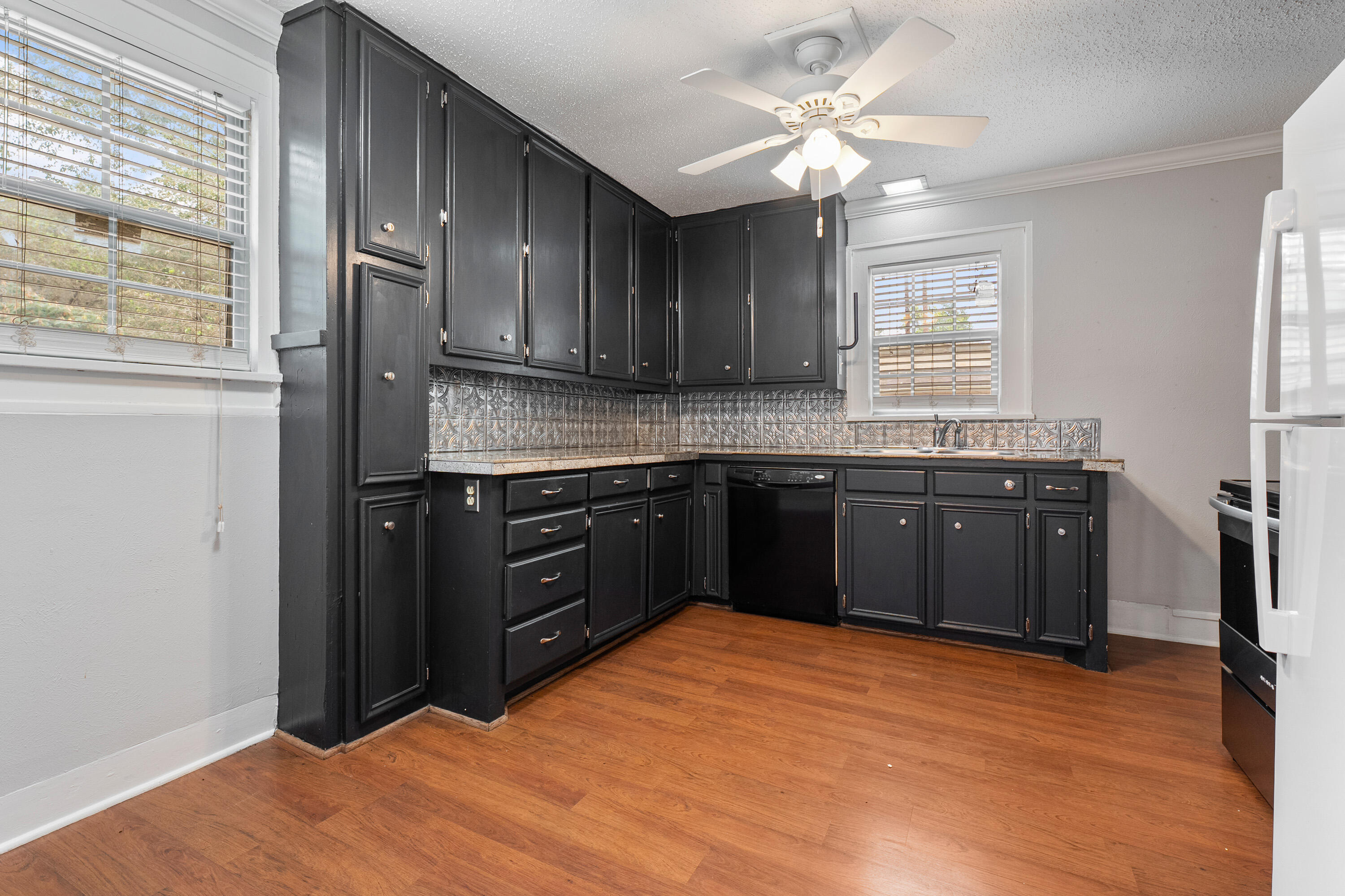 2702 23rd Street Lubbock, TX 79410 - Photo 9 of 30 a kitchen with granite countertop a sink cabinets and stainless steel appliances