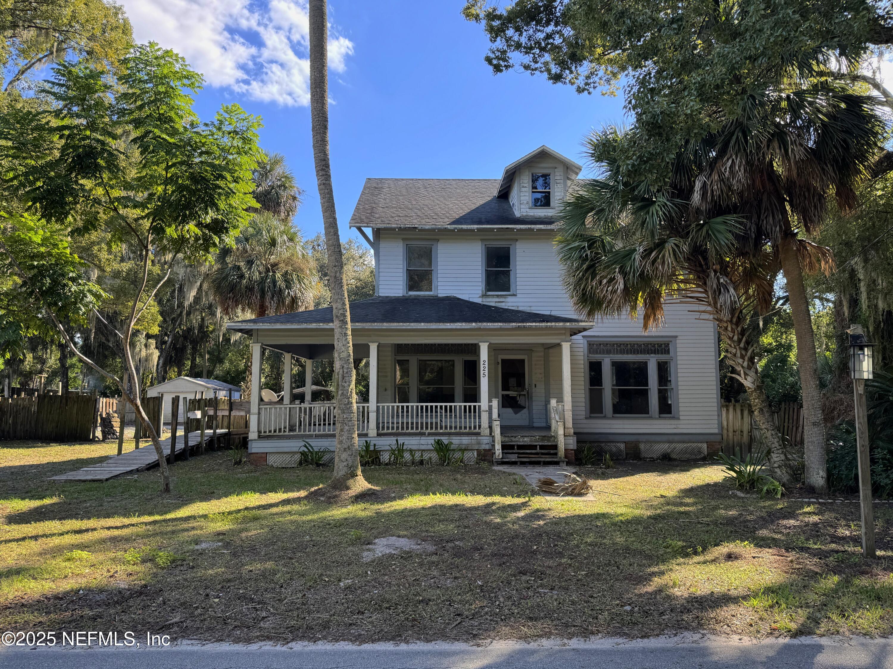 225 Lake George Road Seville, FL 32190 - Photo 2 of 37 a front view of a house with swimming pool