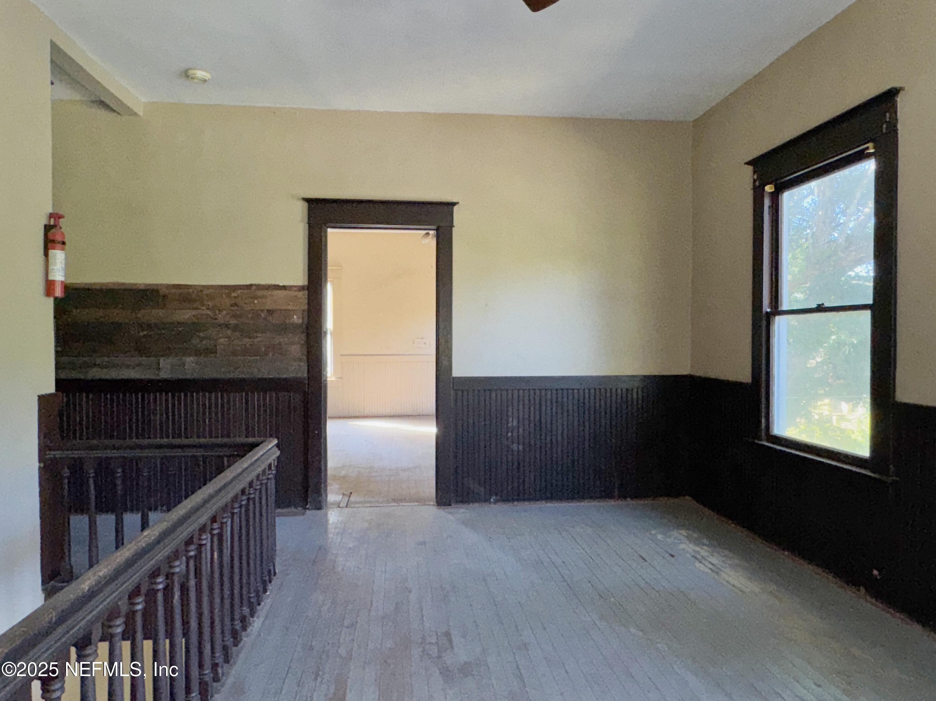 225 Lake George Road Seville, FL 32190 - Photo 22 of 37 a view of hallway with window and wooden floor