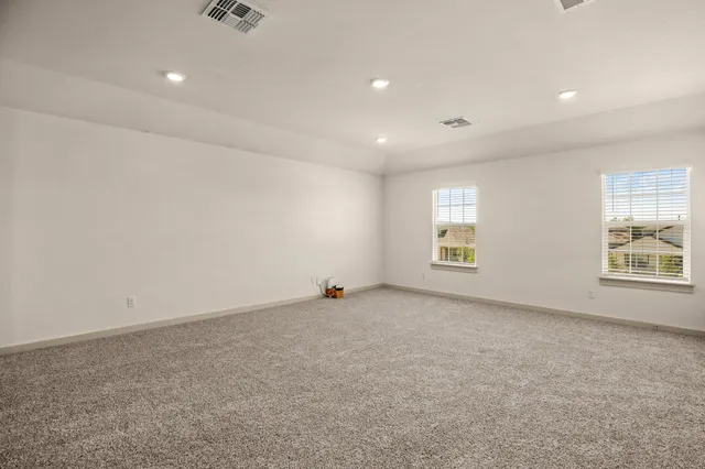 an empty room with windows and closet