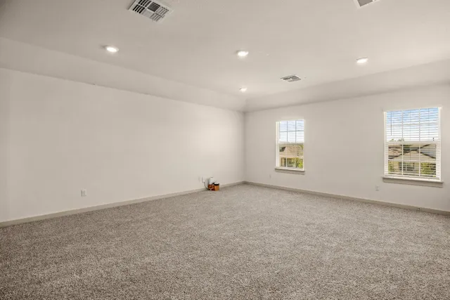 an empty room with windows and closet