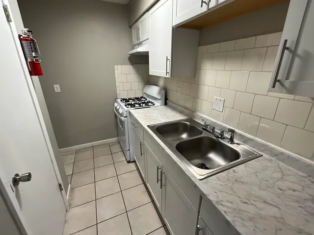 a kitchen with a stove and a sink