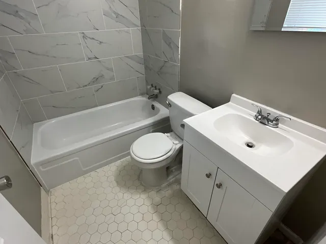 a bathroom with a sink toilet and bathtub
