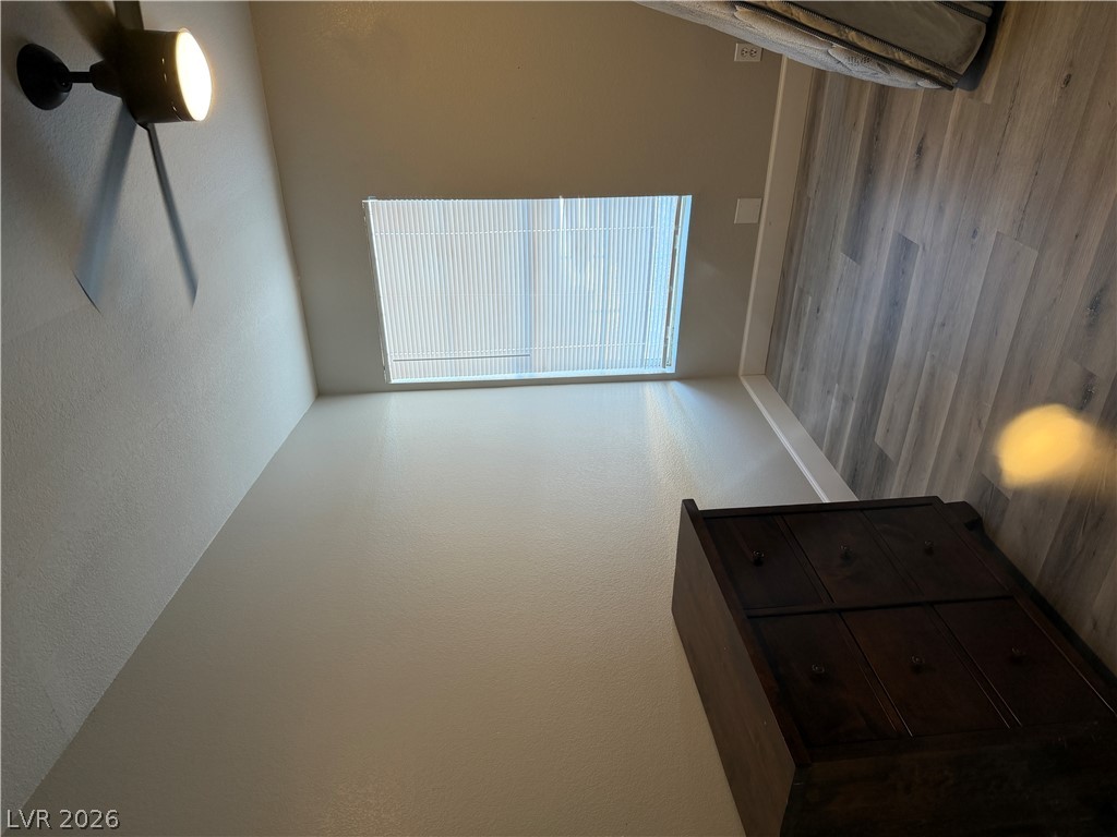 6041 Hafen Ranch Road Pahrump, NV 89061 - Photo 10 of 12 A well-lit bedroom featuring durable plank flooring and a window with blinds for privacy.