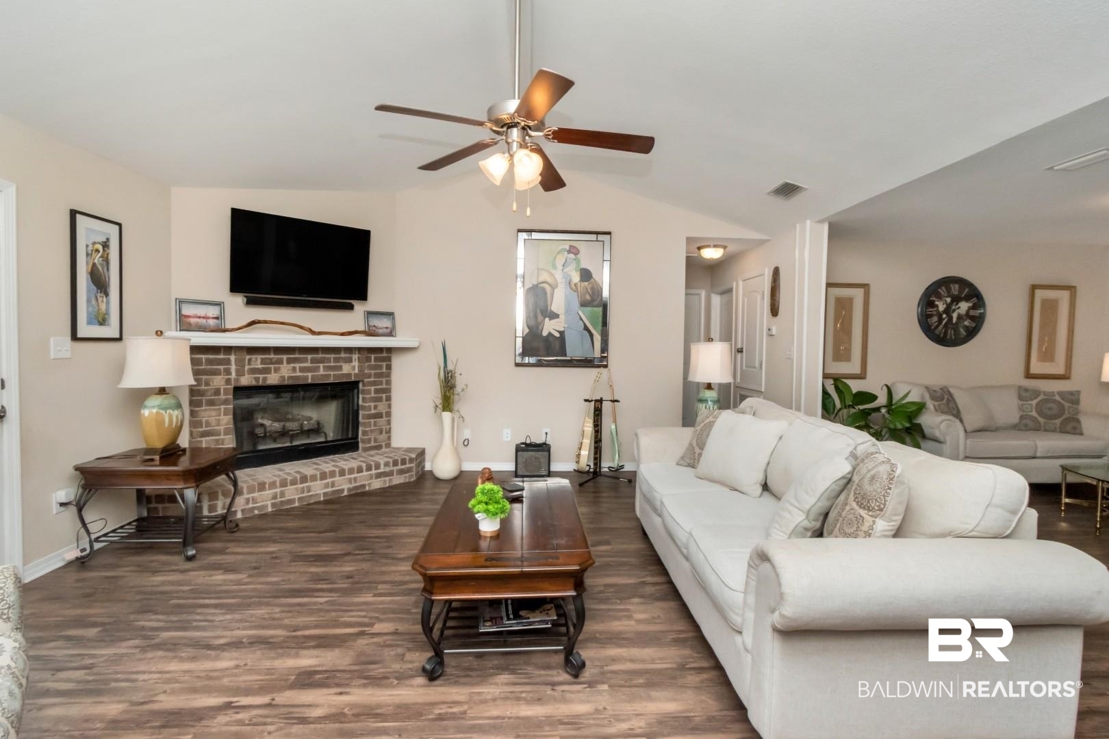 11528 Mocking Bird Lane Fairhope, AL 36532 - Photo 8 of 45 Living area with dark wood-type flooring, a ceiling fan, a brick fireplace, and lofted ceiling