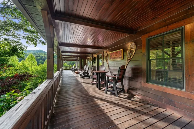 a spacious bedroom with a bed a dresser and a bookshelf