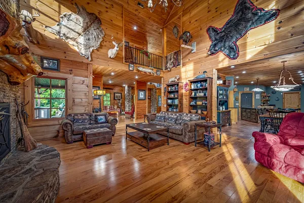 a kitchen with stainless steel appliances granite countertop a refrigerator a stove and a sink with wooden floor