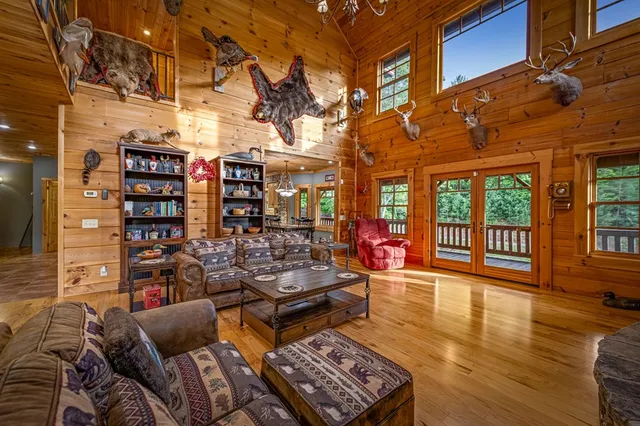 a living room with furniture a fireplace and a large window