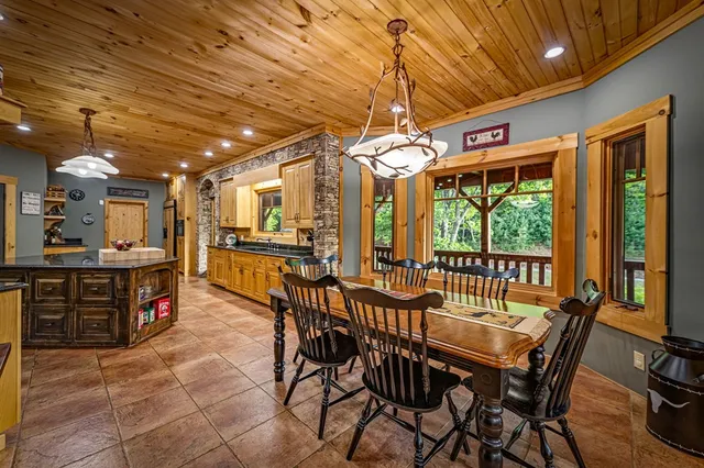 a kitchen with a sink and a stove with chairs