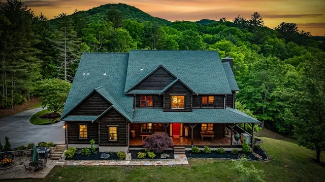 an aerial view of a house roof deck with chairs and a yard