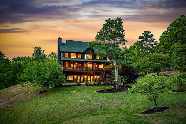a view of a lush green hillside and houses