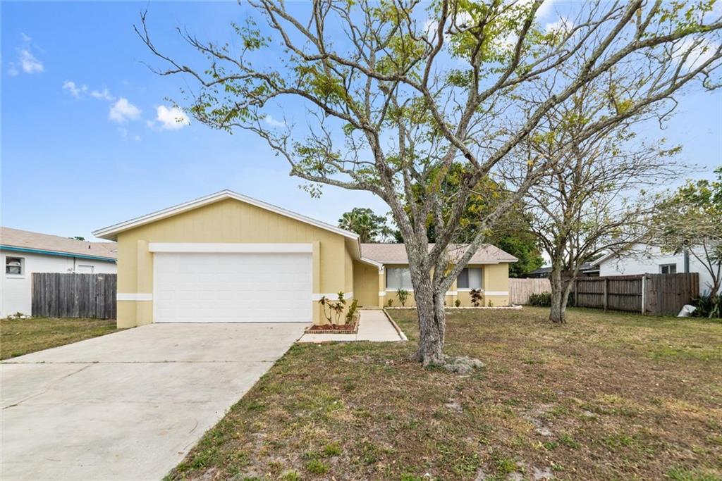 8405 Mattituck Circle Orlando, FL 32829 - Photo 1 of 1 a front view of a house with a yard and garage