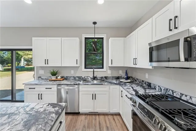 a kitchen with a stove a sink and a microwave