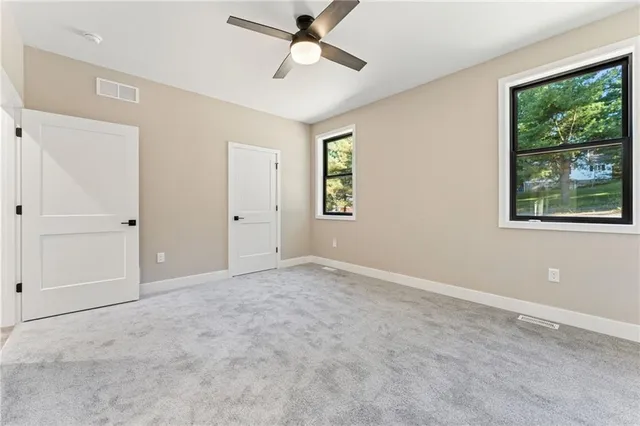 an empty room with windows and closet