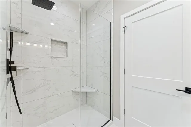 a bathroom with a shower and a glass door
