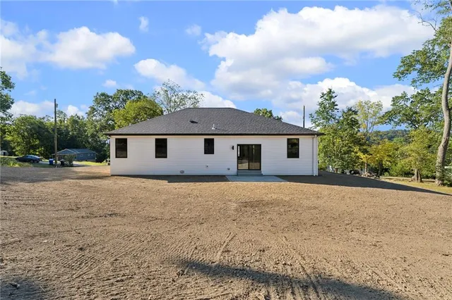 a view of a house with a yard and potted plants