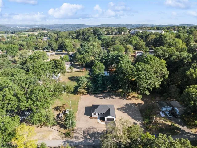 an aerial view of a houses with a yard