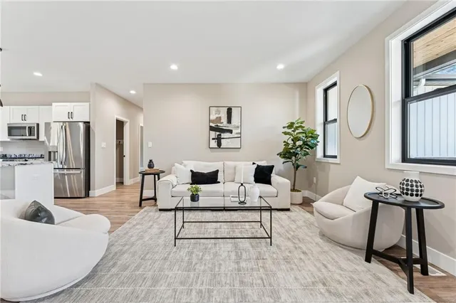 a living room with furniture and a potted plant
