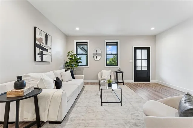 a living room with furniture and wooden floor