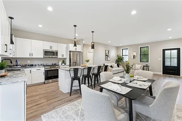 a large kitchen with a table and chairs